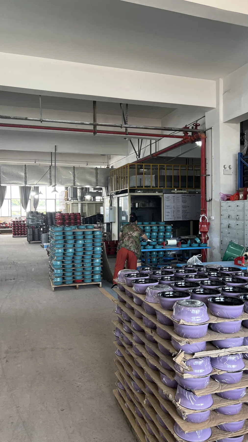 Finished enameled cast iron cookware staged in the factory before packing