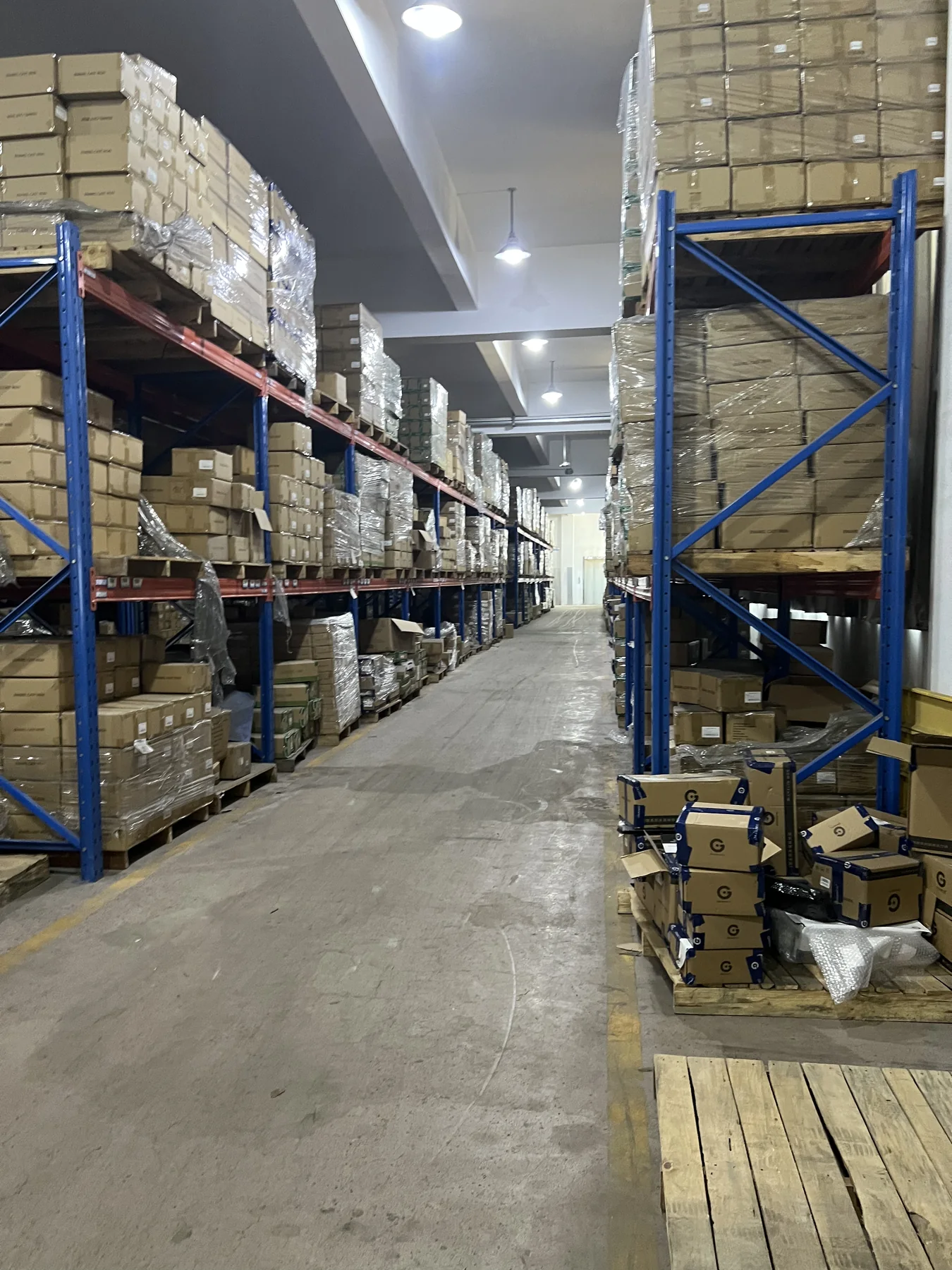 Packaged cookware cartons stored on warehouse racks before shipment