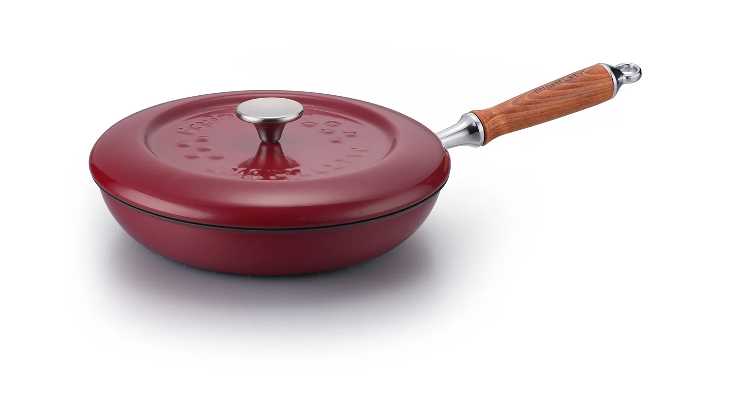 Red enameled cast iron skillet on a factory inspection table